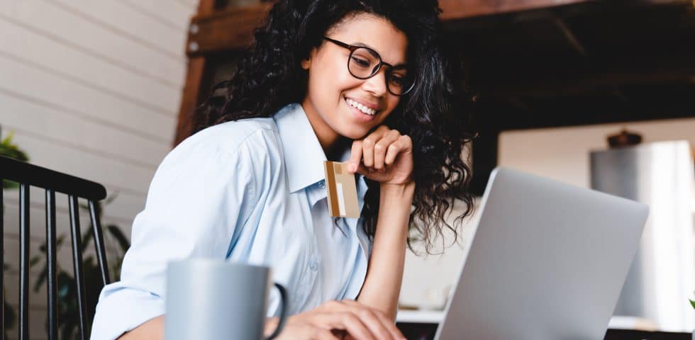 Woman pays bill online with credit card.